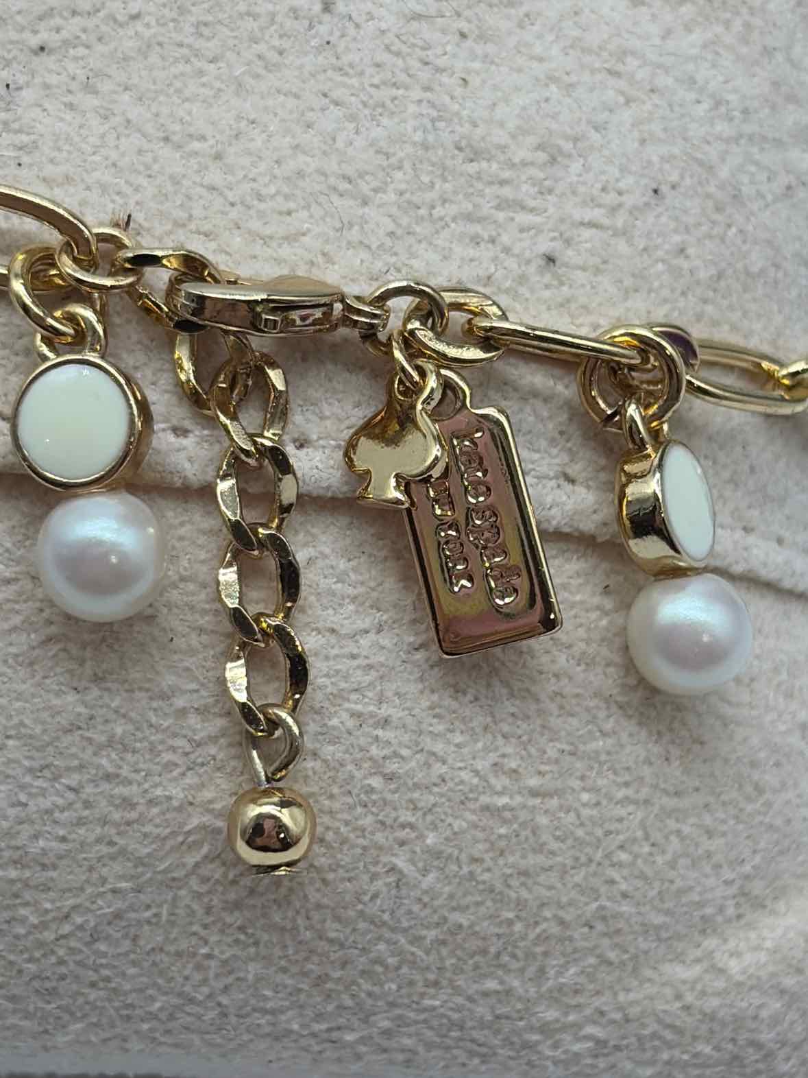 Pre-Owned Kate Spade Gold and White Beads Clasp Bracelet | True Fashionistas.
